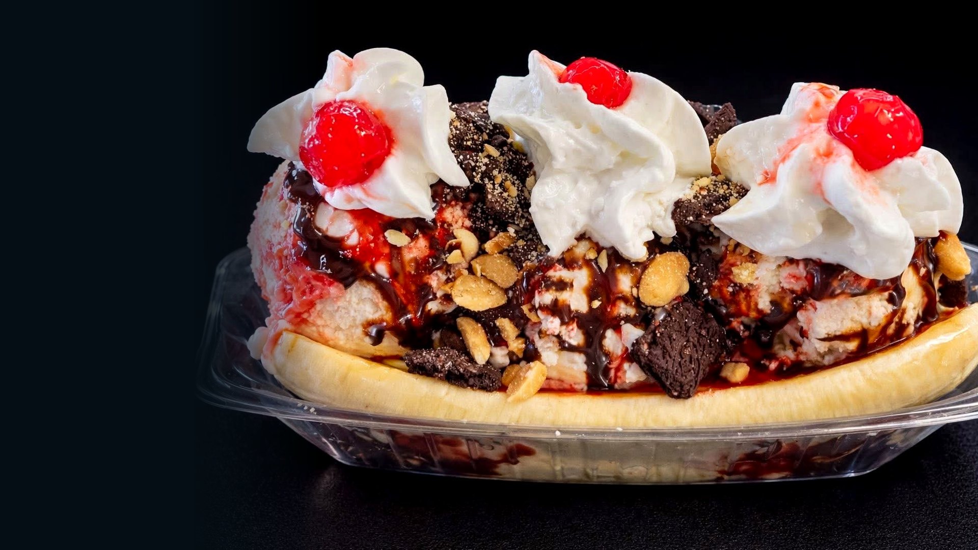 Three scoops, whipped cream, nuts and cherries at Unbothered Scoops